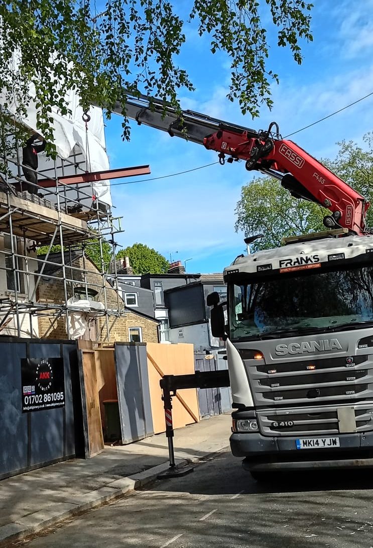 Steel beam installation for a loft conversion project in Newham E7 using a crane and scaffolding by Franks Steel.