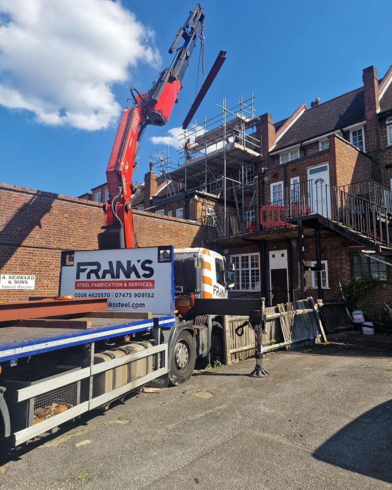 Franks Steel crane delivery unloading structural steel beams at Bowes Road Arnos Grove N11