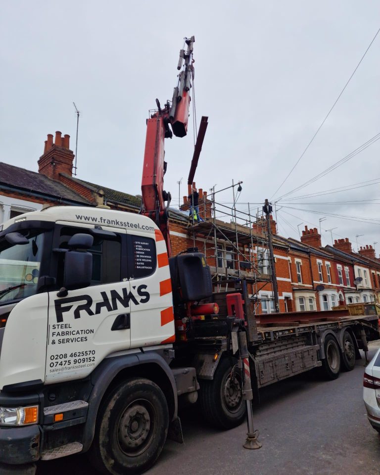 Franks Steel crane lifting structural steel beam at residential project in Guildford RH1
