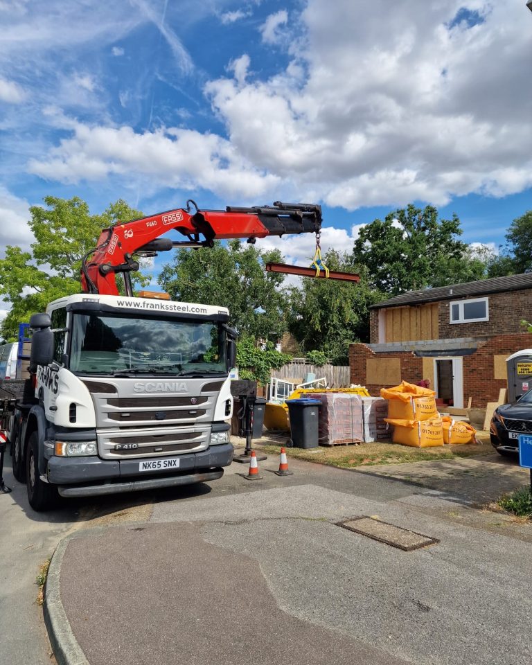 Franks Steel crane delivery unloading structural steel beam at project in Kingston Upon Thames KT1