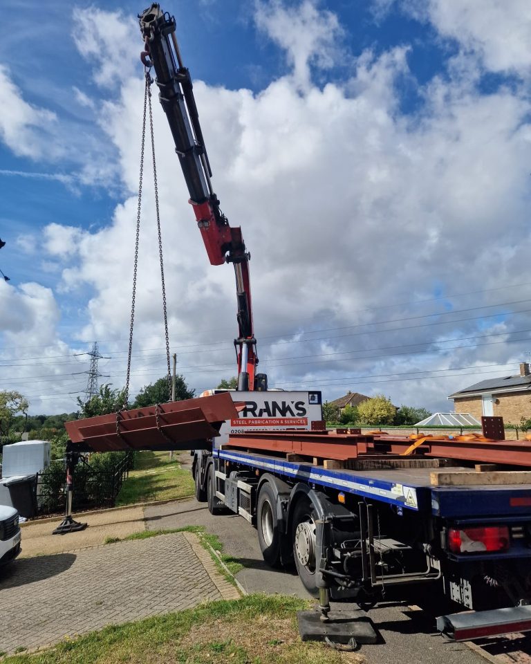 Franks Steel crane delivery unloading structural steel beams at project in Romford RM1