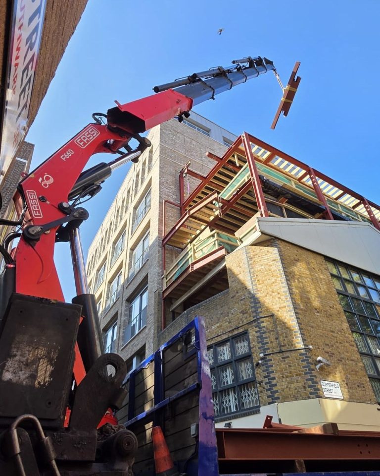 Steel fabricators Southwark SE1 lifting structural steel beams at Copperfield Street London