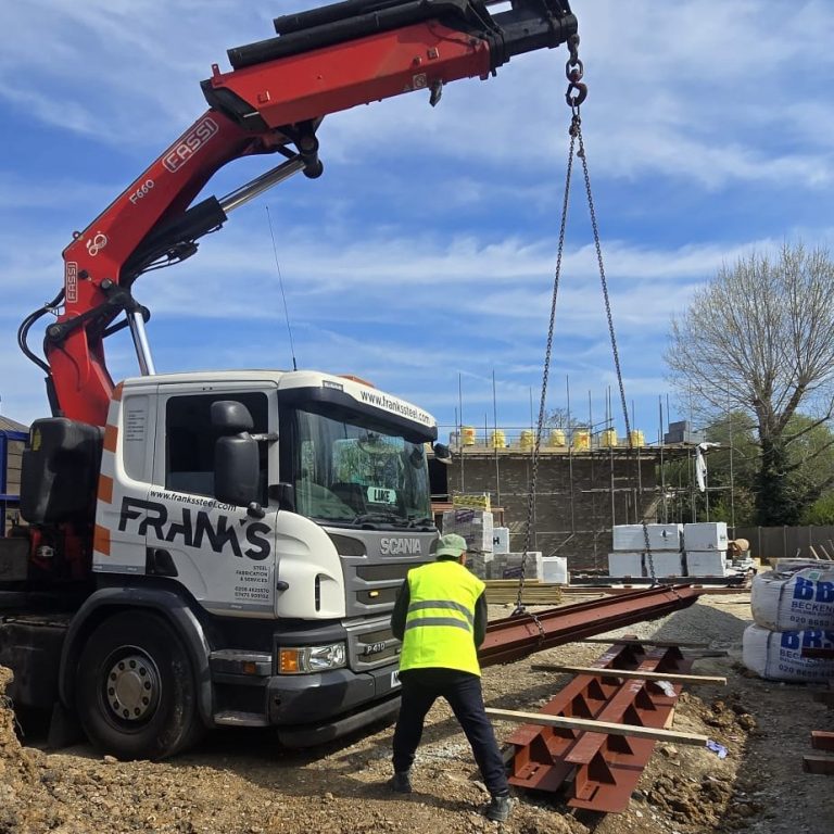 Franks Steel crane delivery unloading structural steel beams at Balmoral Road Watford WD2