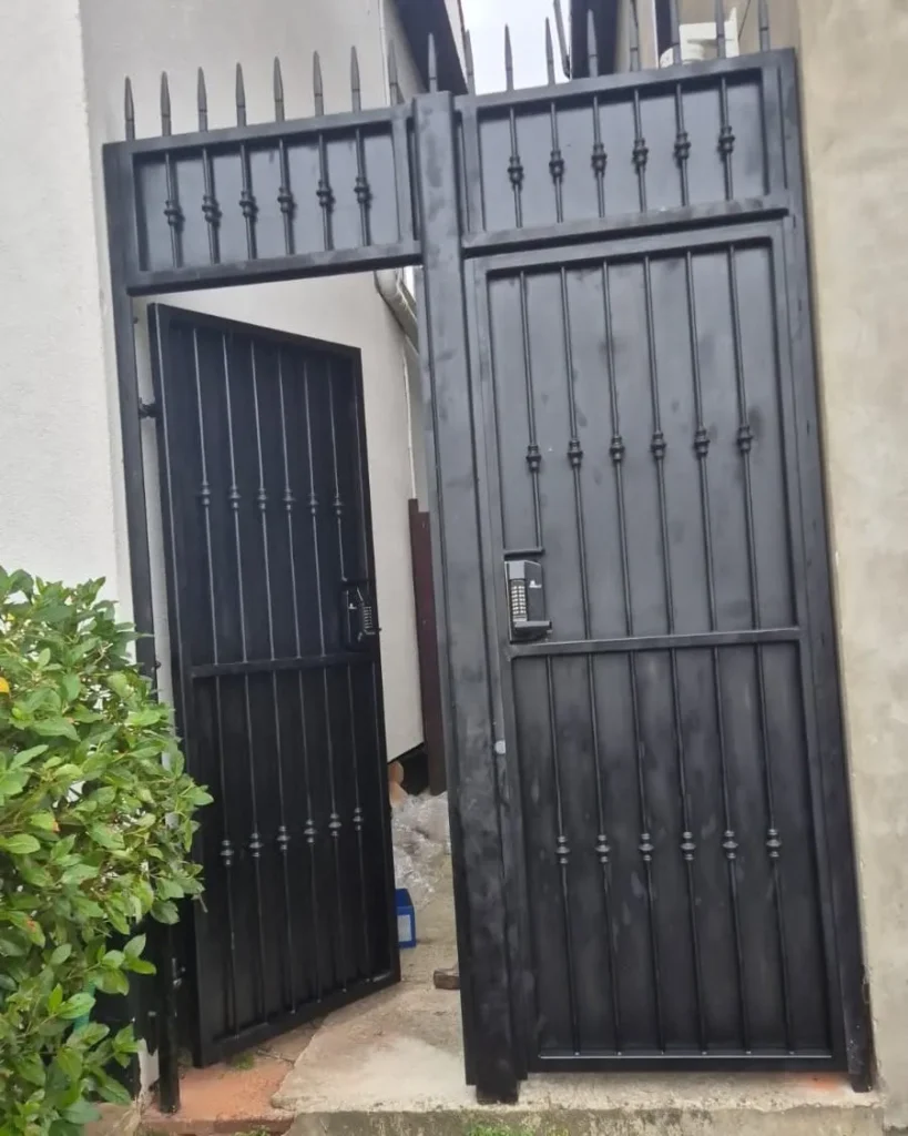 Bespoke black metal security gate with keypad access manufactured and installed by Franks Steel.