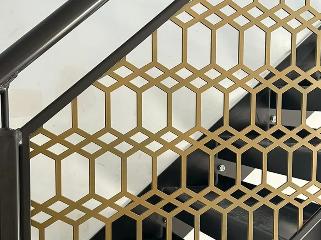Custom metal staircase with decorative laser-cut steel balustrade fabricated and installed by Franks Steel.