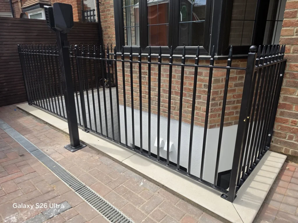 Custom black steel railings installed around a basement lightwell providing safety, security and a modern finish by Franks Steel.
