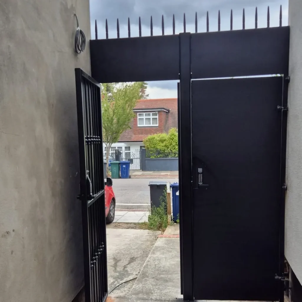 Custom black steel side access gate with keypad entry fabricated and installed by Franks Steel.